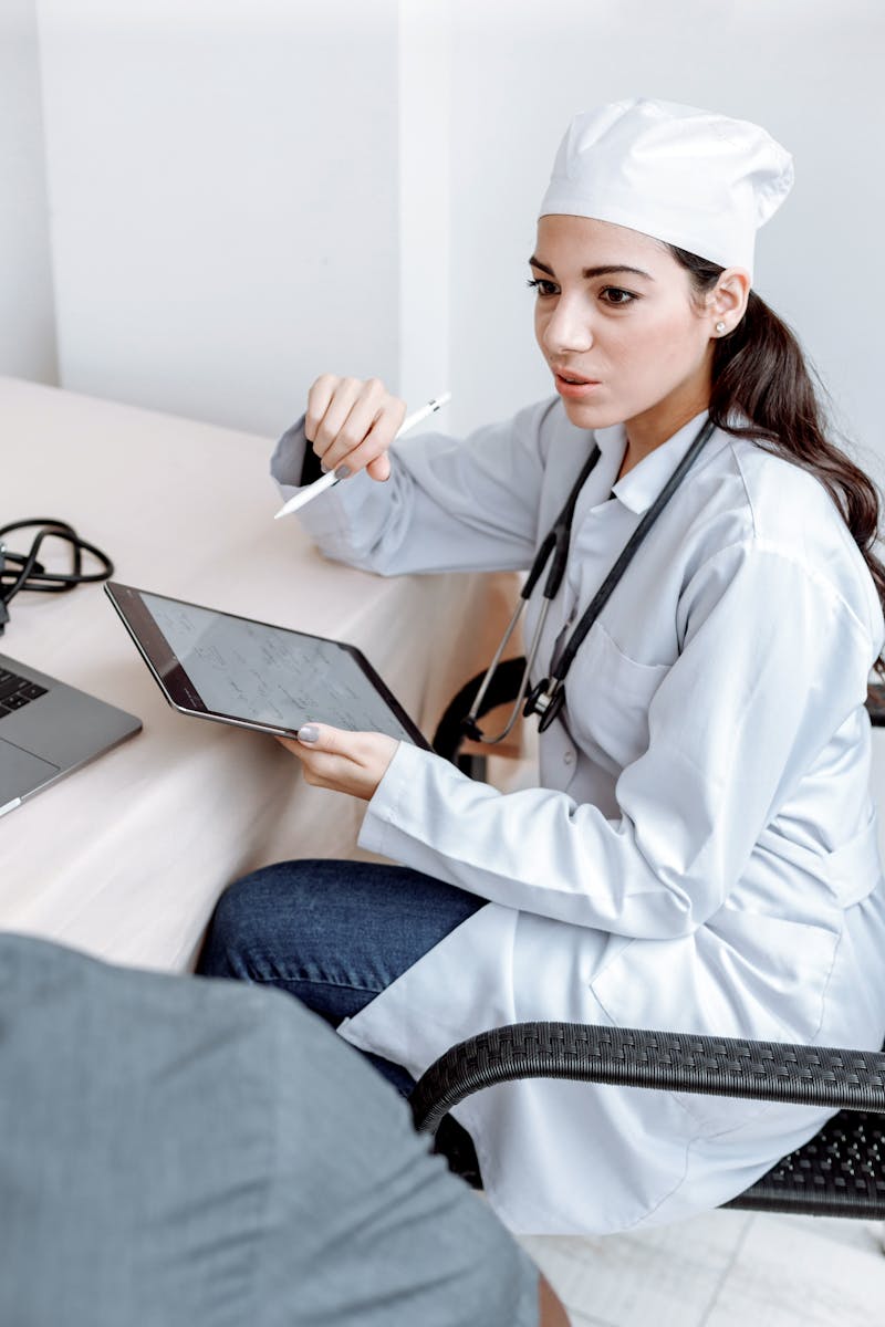 Healthcare professional with tablet and report
